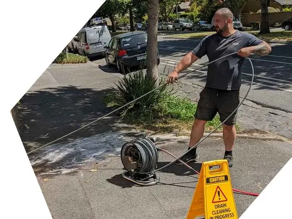 Plumber in Ashwood 3147 unblocking a drain with water jet machine