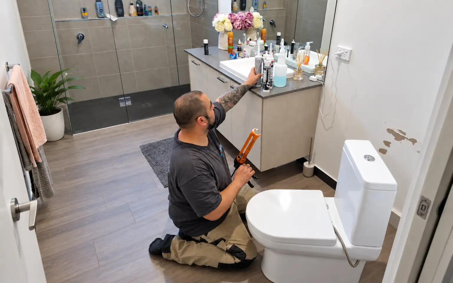 Oakleigh plumber 13 Dennis completing plumbing work beside a toilet